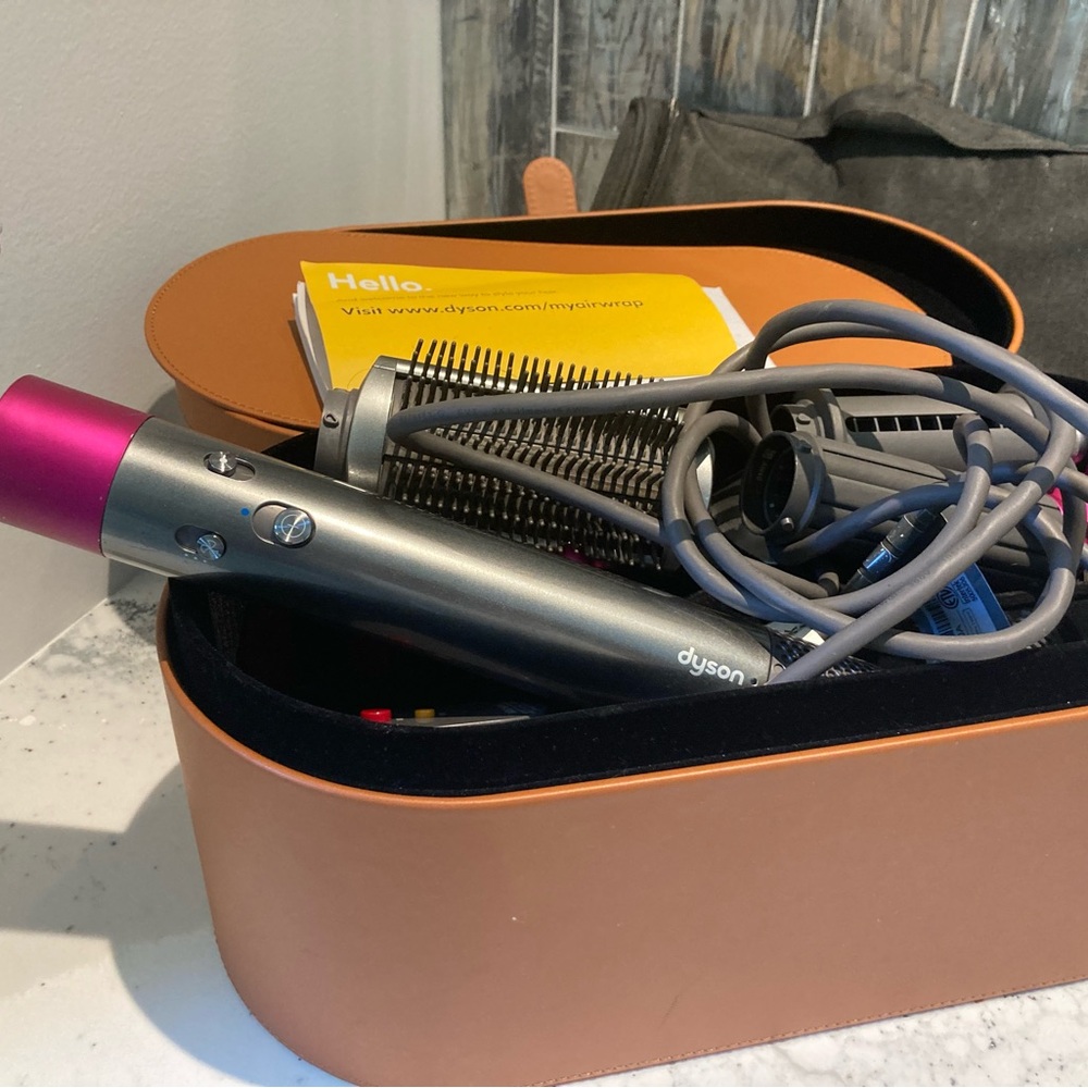 Dyson Airwrap W/original attachments and three extra attachments. Travel case.